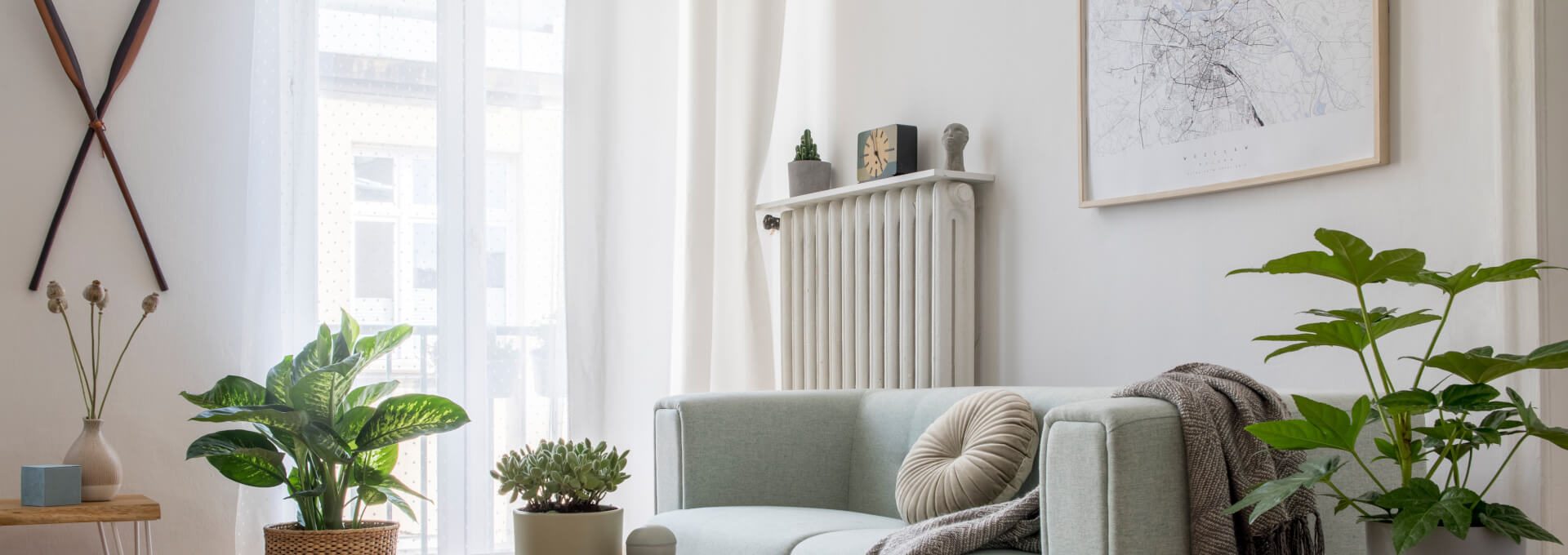 a living room with a couch, coffee table and plants at The  Sophia