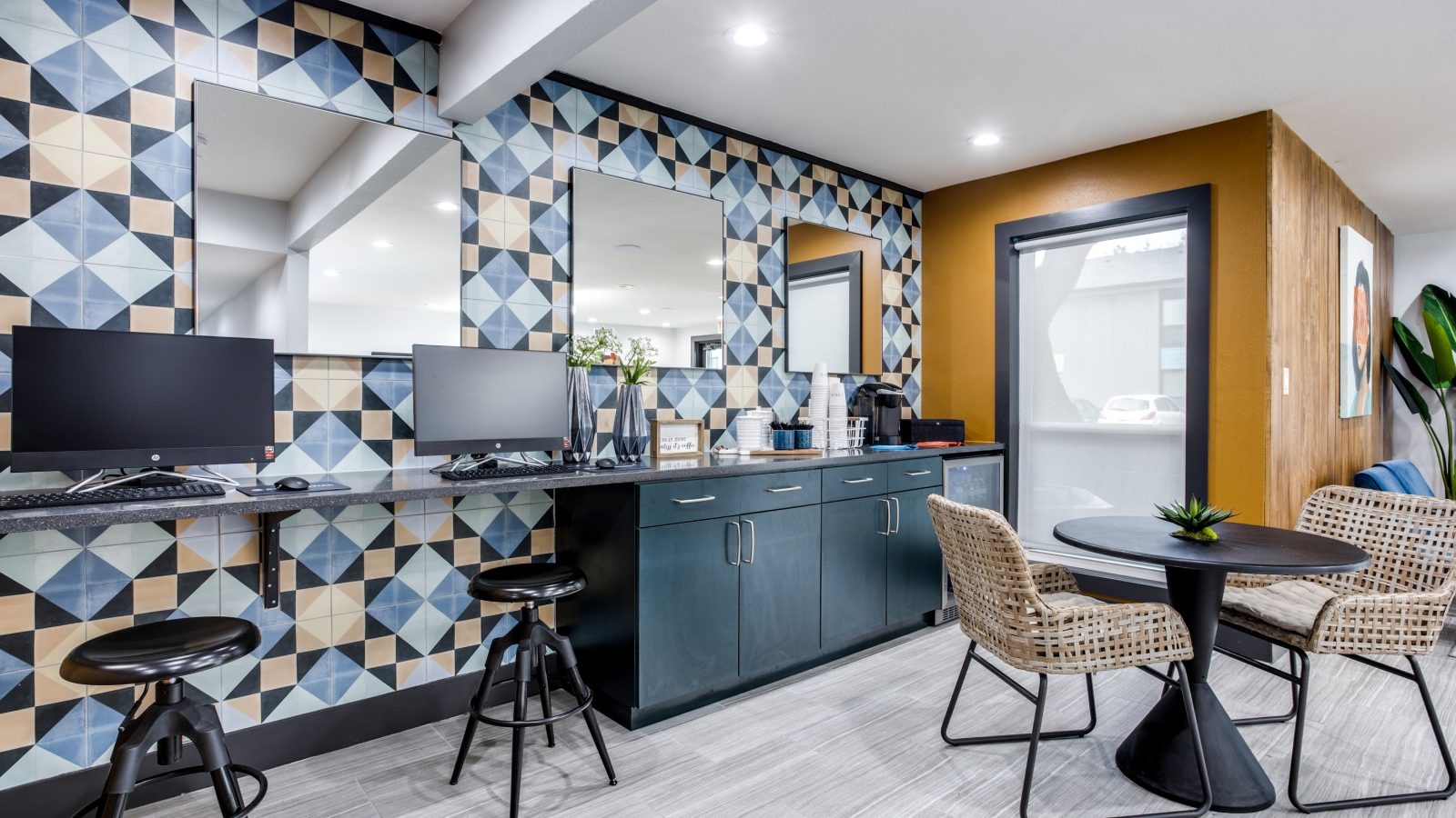 a kitchen with a blue and yellow tile pattern at The  Sophia